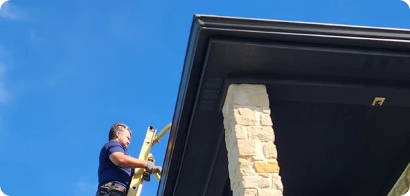 Installing new gutters on a Central Texas home.